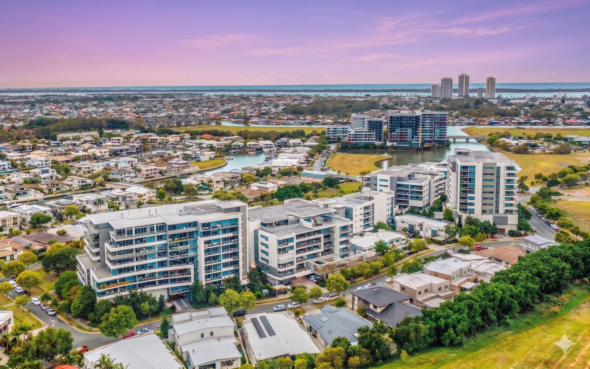 Aerial view of canal-side Gold Coast strata buildings at dusk