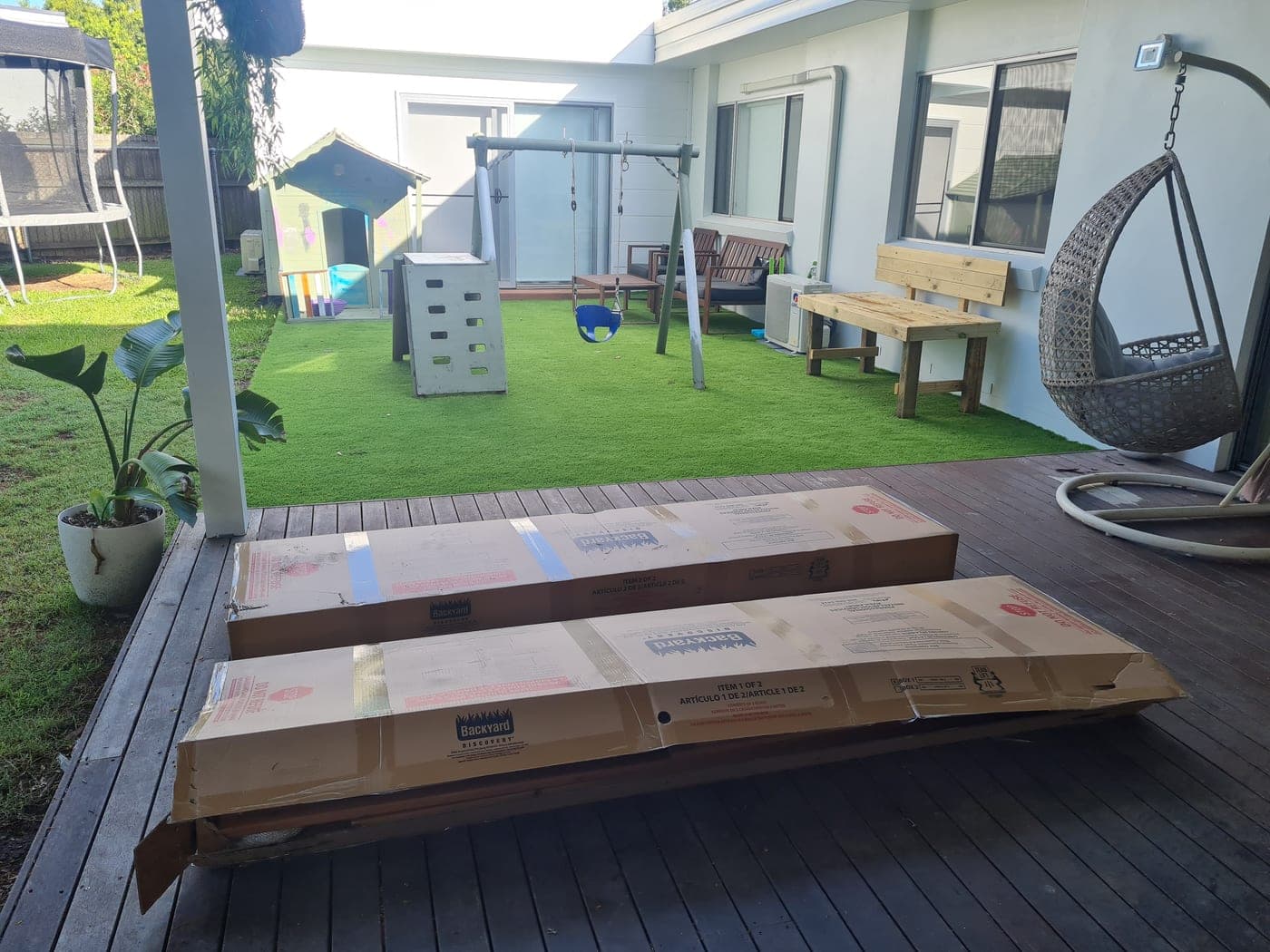 Flat-packed playset boxes on the deck before the build