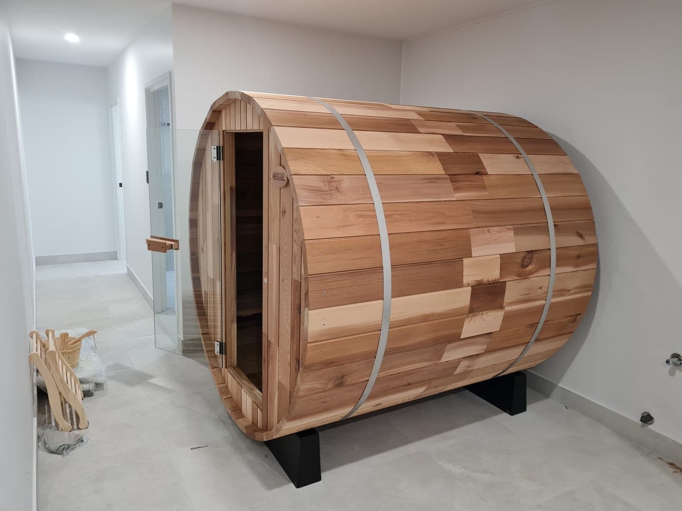 Finished cedar barrel sauna with a glass door