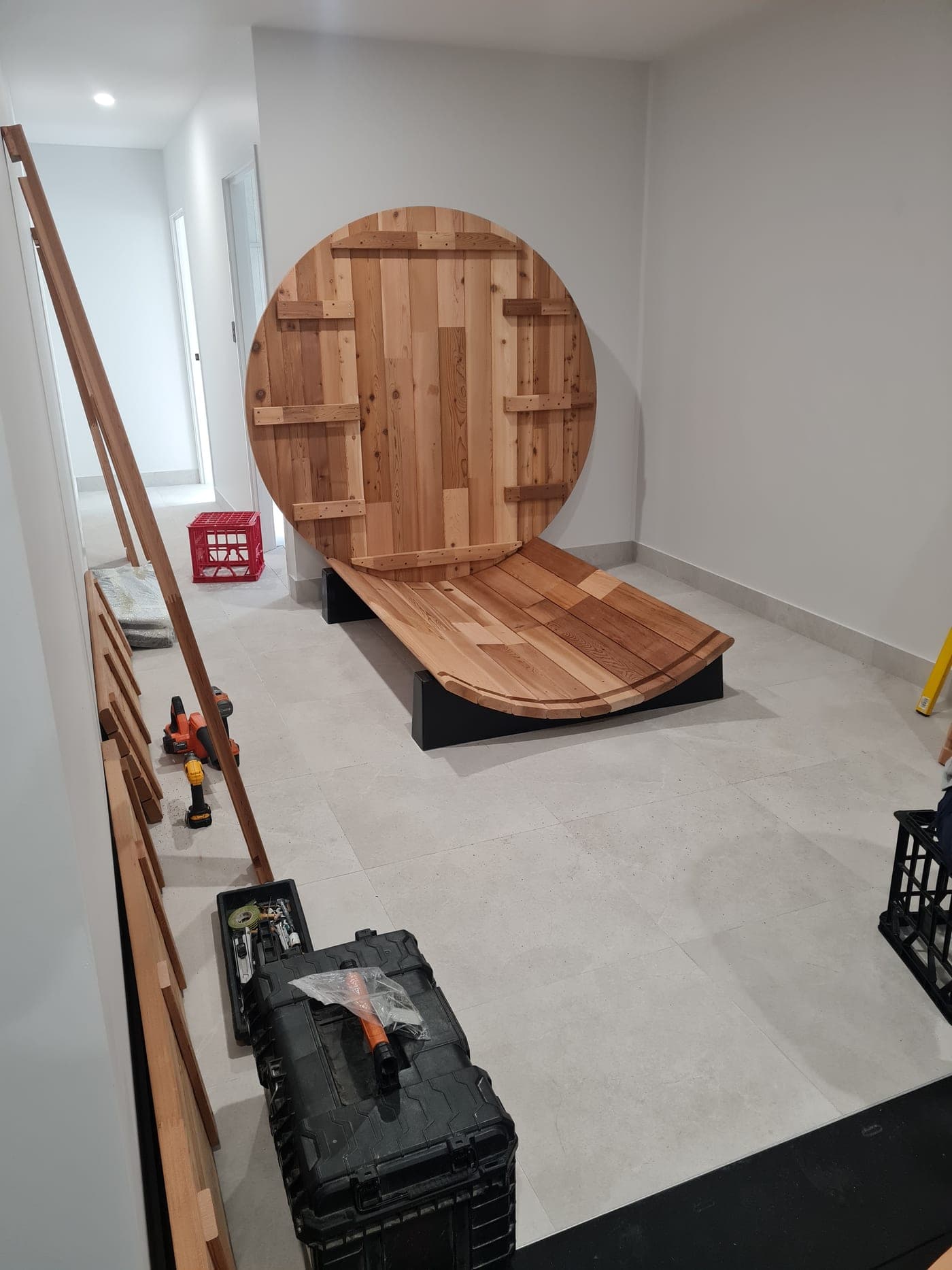 Cedar barrel sauna part-assembled indoors