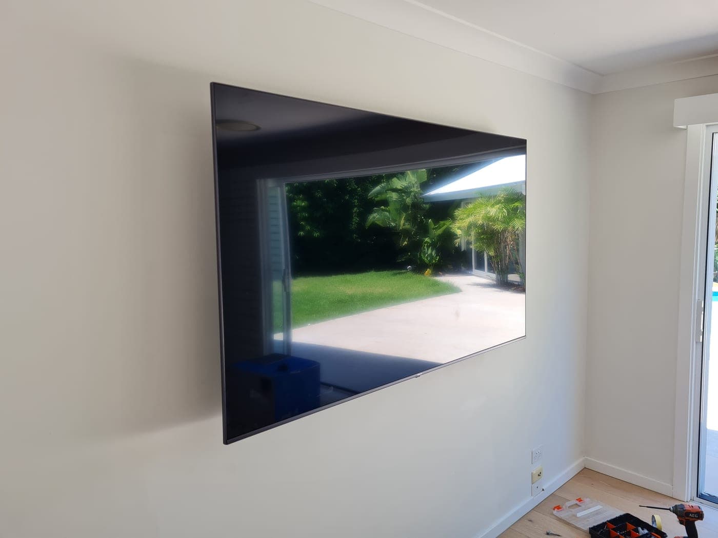 Large TV flush-mounted on the wall with the cables hidden