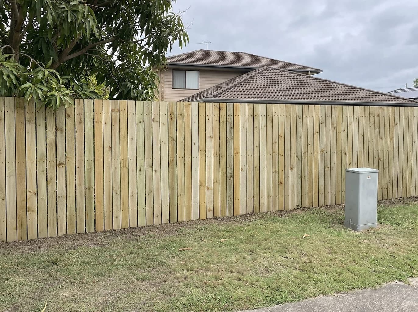 The same boundary with a straight new timber paling fence