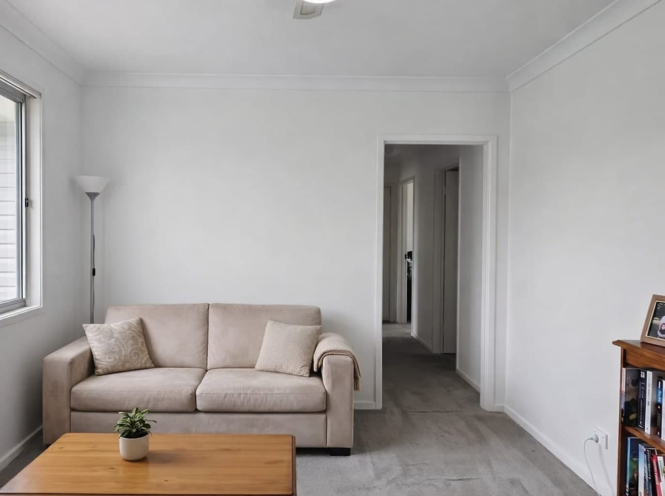 The same room freshly painted in off-white, with crisp white skirtings and architraves